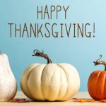 Thanksgiving message with pumpkins on a blue backgroun